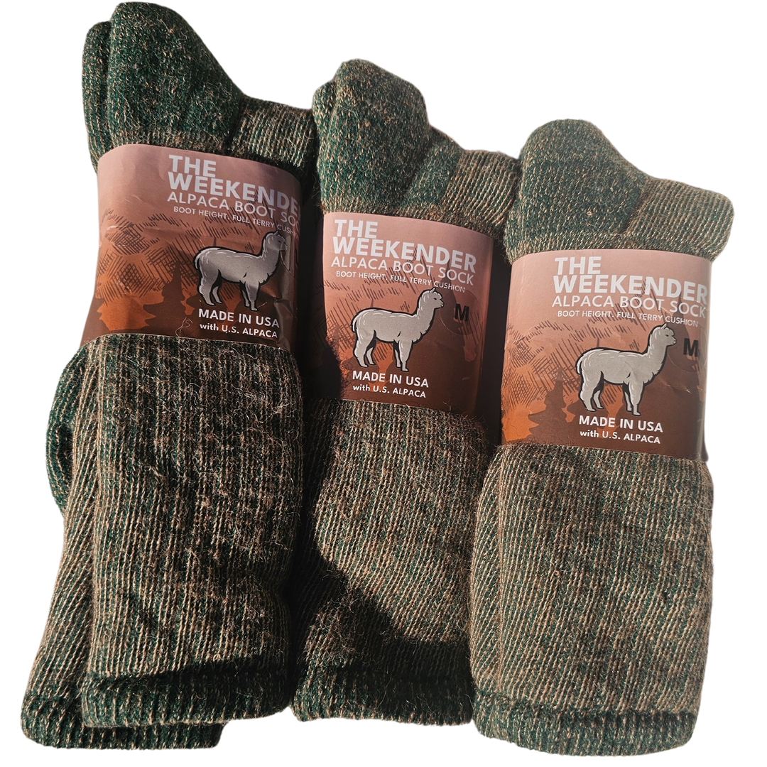 The Weekender alpaca socks folded neatly on a wooden surface, showcasing their soft texture and cozy design for warmth and style.