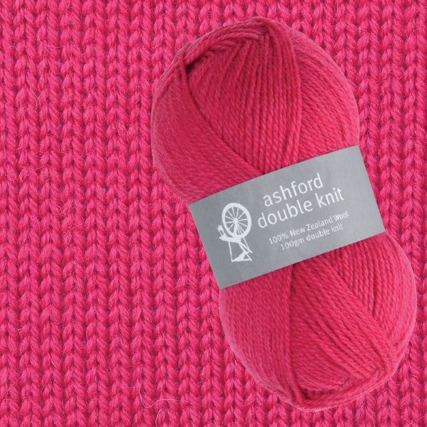 Pink yarn skein with 'ashford double knit' label on a pink knitted background