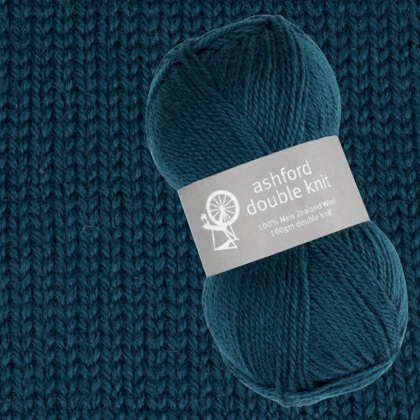 Blue yarn ball with 'ashford double knit' label on a knitted fabric background