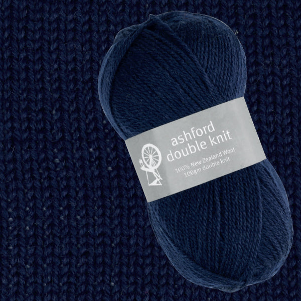 Navy blue yarn ball with Ashford Double Knit label on a textured navy background