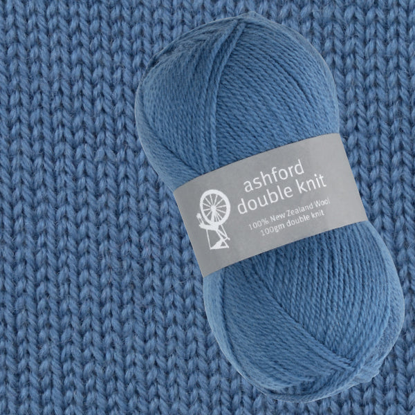Blue yarn ball with Ashford Double Knit label on a knitted fabric background