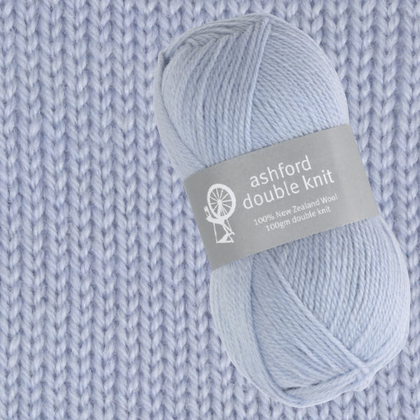 Ball of yarn with Ashford Double Knit label on a knitted fabric background