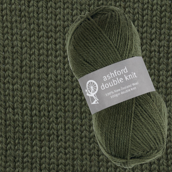 Green ball of yarn with 'ashford double knit' label on a knitted fabric background