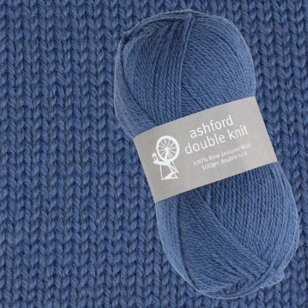 Blue yarn ball with 'ashford double knit' label on a knitted fabric background