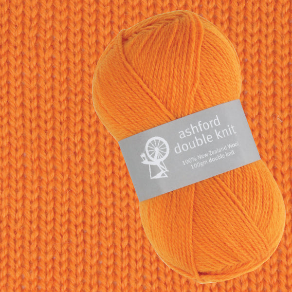 Orange yarn ball with 'ashford double knit' label on an orange knitted background