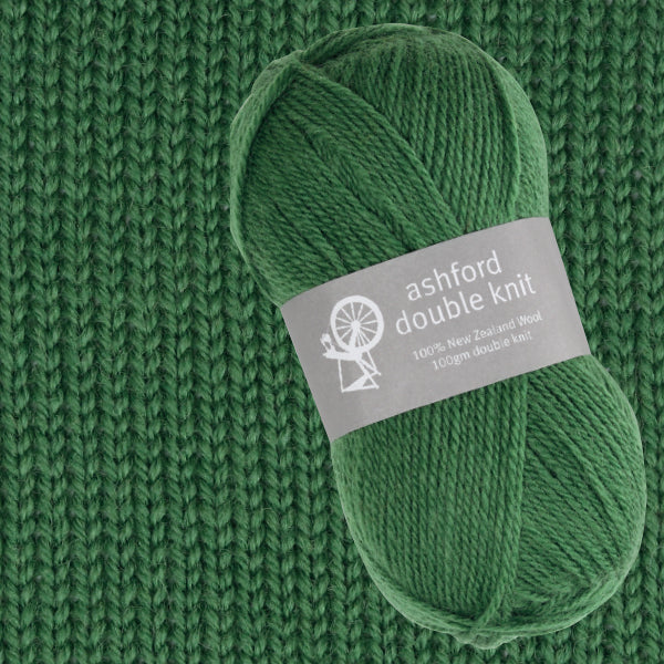 Green yarn ball with 'ashford double knit' label on a knitted green background