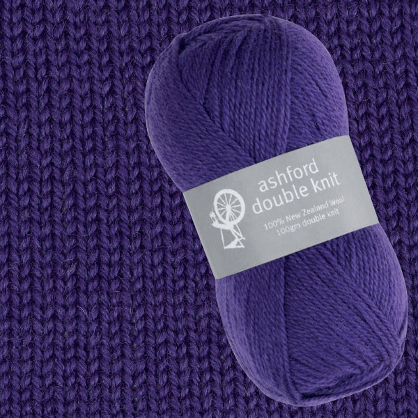 Purple yarn skein with 'ashford double knit' label on a knitted background