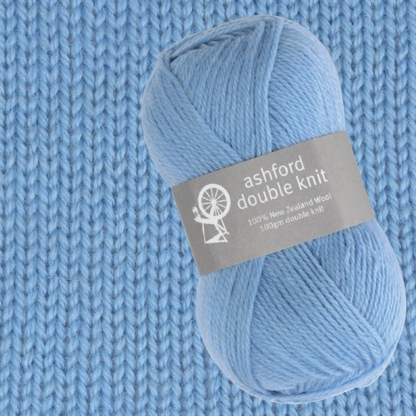 Blue skein of yarn with Ashford Double Knit label on a knitted fabric background