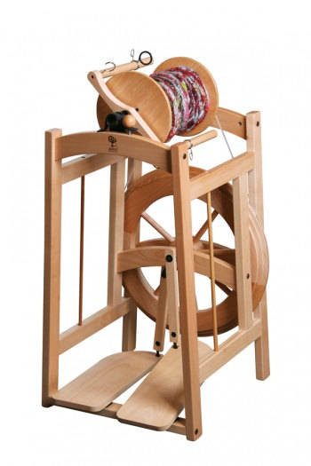 Ashford Country Spinner 2: A durable, double treadle spinning wheel for crafting bulky yarns. Its foot-powered motion ensures smooth operation, and the natural wood finish adds a touch of elegance to your fiber art projects.