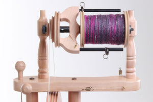 Detailed image of the Ashford Traveller 3's bobbin system, highlighting the wheel's capacity for multiple spinning ratios suited for fiber art enthusiasts.
