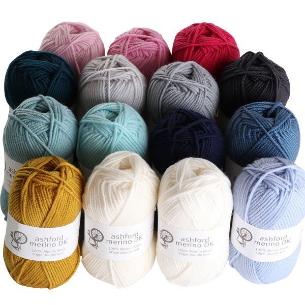 Assorted skeins of yarn in various colors with Ashford Merino DK labels.