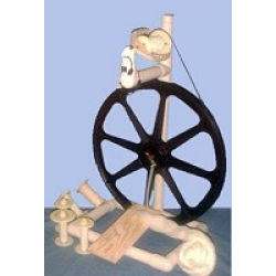A robust and stable black single treadle Babe's Production Spinning Wheel, offering artisans a reliable tool for continuous spinning sessions.