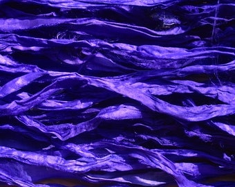 Electric Violet Recycled Sari Silk Ribbon is used in a weaving project, showcasing its versatility in textile arts.