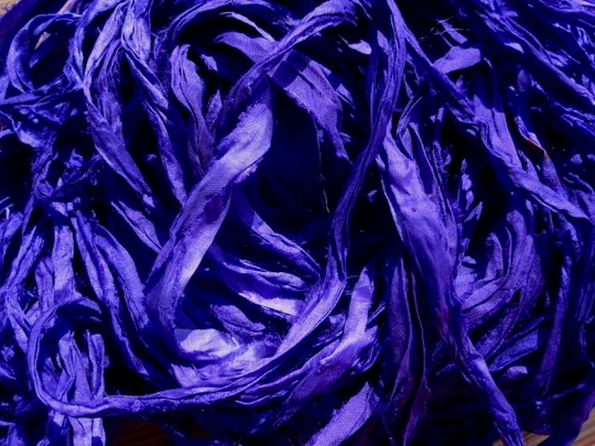Close-up view of Electric Violet Recycled Sari Silk Ribbon highlighting its intricate texture and rich color, perfect for crafting.