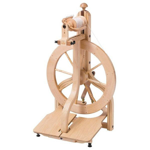 Full view of the Schacht Matchless Spinning Wheel set against a white background, highlighting its full 19.5-inch drive wheel and sturdy build, an ideal choice for fiber artists seeking quality and durability.