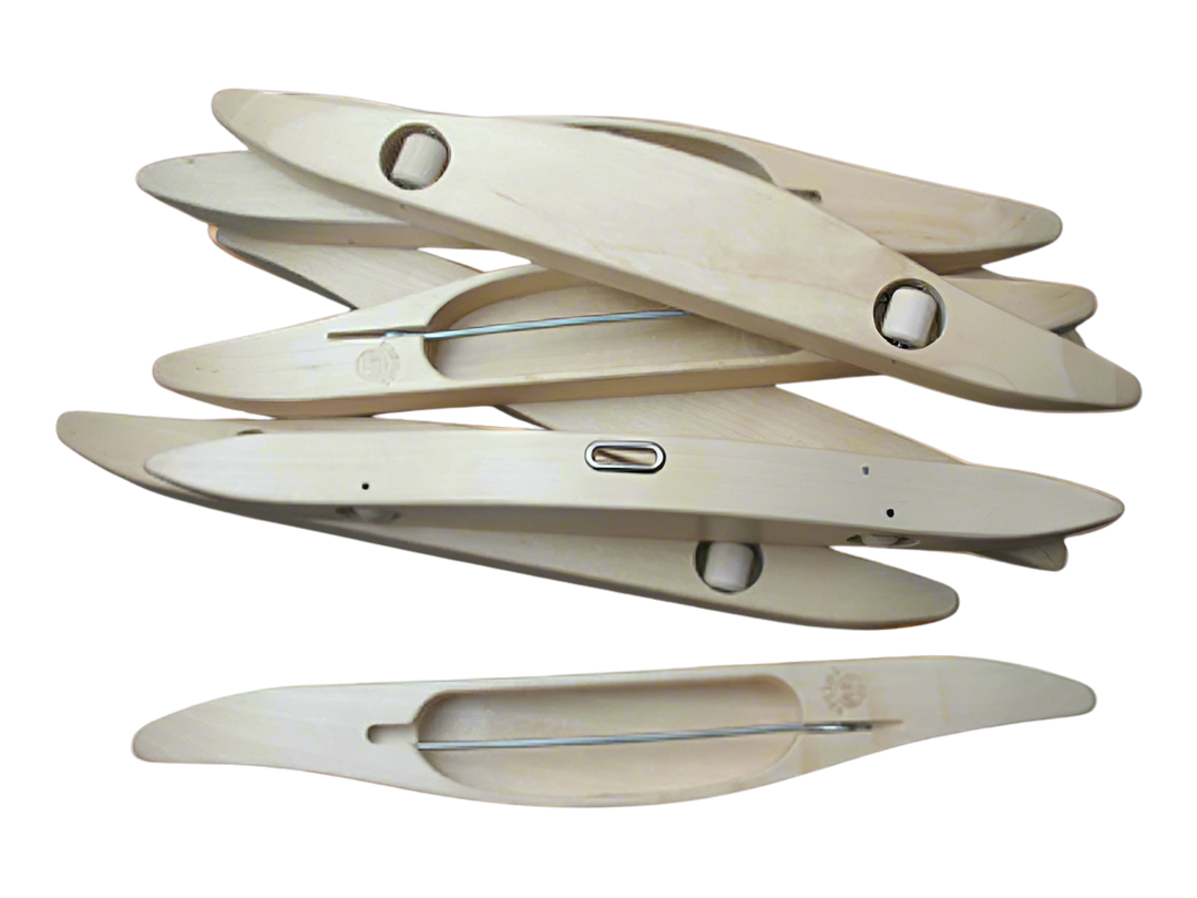 A variety of Glimakra boat shuttle displayed in an elegant pile