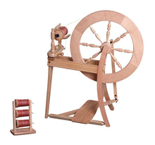 Load image into Gallery viewer, A handcrafted traditional single drive spinning wheel made from durable natural wood, with a smooth finish enhancing its timeless aesthetic. Perfect for spinning enthusiasts, it features precisely turned wheel spokes and a functional bobbin holder loaded with high-quality red yarn.
