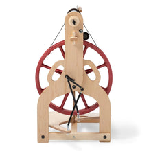 Load image into Gallery viewer, A rear perspective of the Ladybug Spinning Wheel illustrates the wheel&#39;s Scotch tension, double drive, and bobbin lead features. The image highlights the wheel&#39;s functional yet stylish construction, complete with accessories like the travel bobbins and whorls that support a range of yarn spinning techniques for the fiber enthusiast
