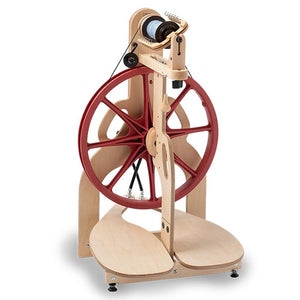 The Ladybug Spinning Wheel presented in a front view, showcasing its compact design with a 16-inch drive wheel and integrated carrying handles. Its sturdy maple construction promises durability and ease of use, making it a favorite among fiber artists for creating yarns with its versatile spinning ratios.