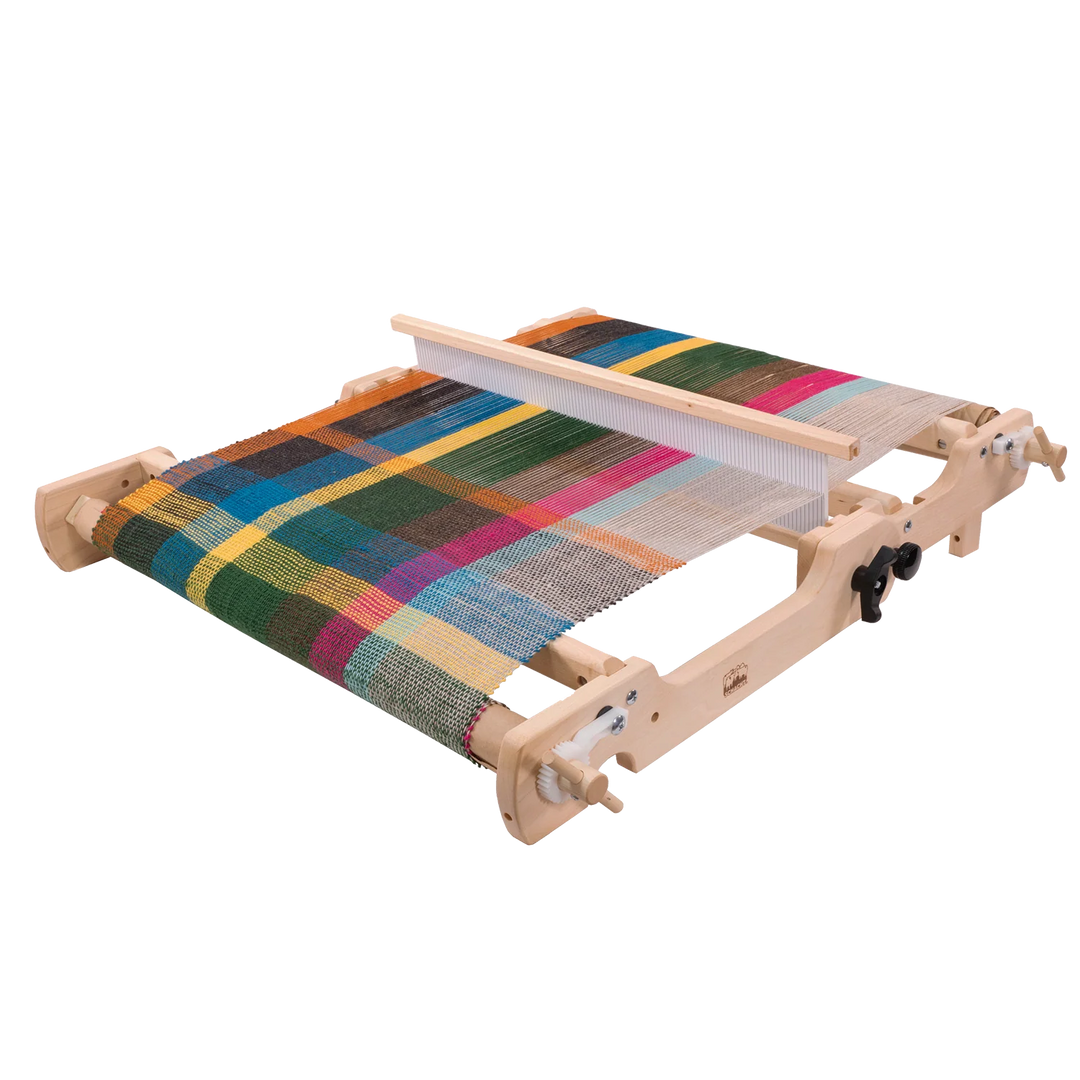 Wooden weaving loom with a multicolored woven fabric on a white background