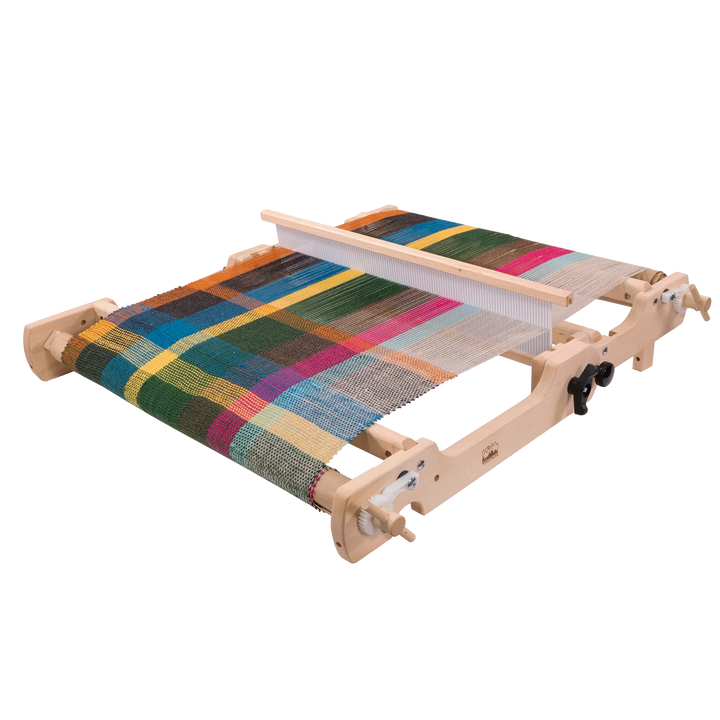 Wooden weaving loom with a multicolored woven fabric on a white background