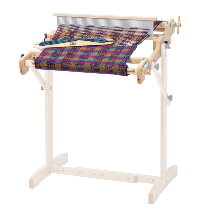 Wooden weaving loom with a multicolored woven fabric on a white background
