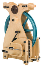 Load image into Gallery viewer, The Schacht Sidekick Spinning Wheel in its folded state highlights its travel-friendly design. The wheel&#39;s compact structure and quick-release levers demonstrate its readiness for the traveling fiber artist without compromising on the quality of spinning.
