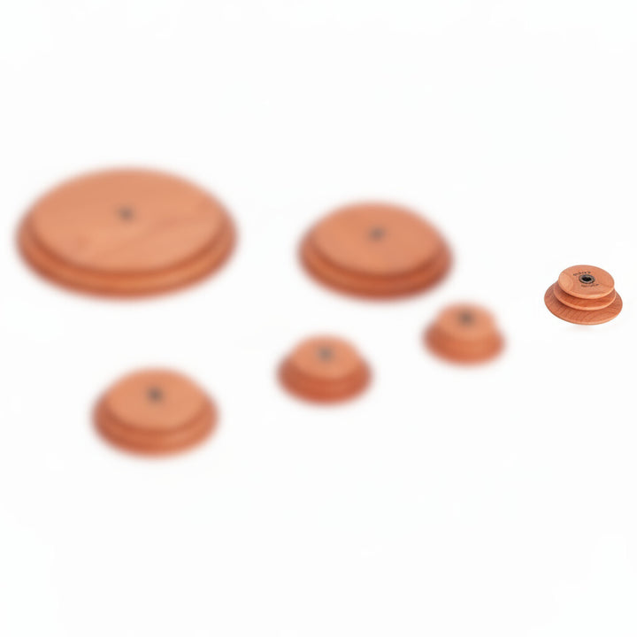 Set of Schacht spinning wheel cherry hardwood whorls with the super high speed whorl highlighted on a white background