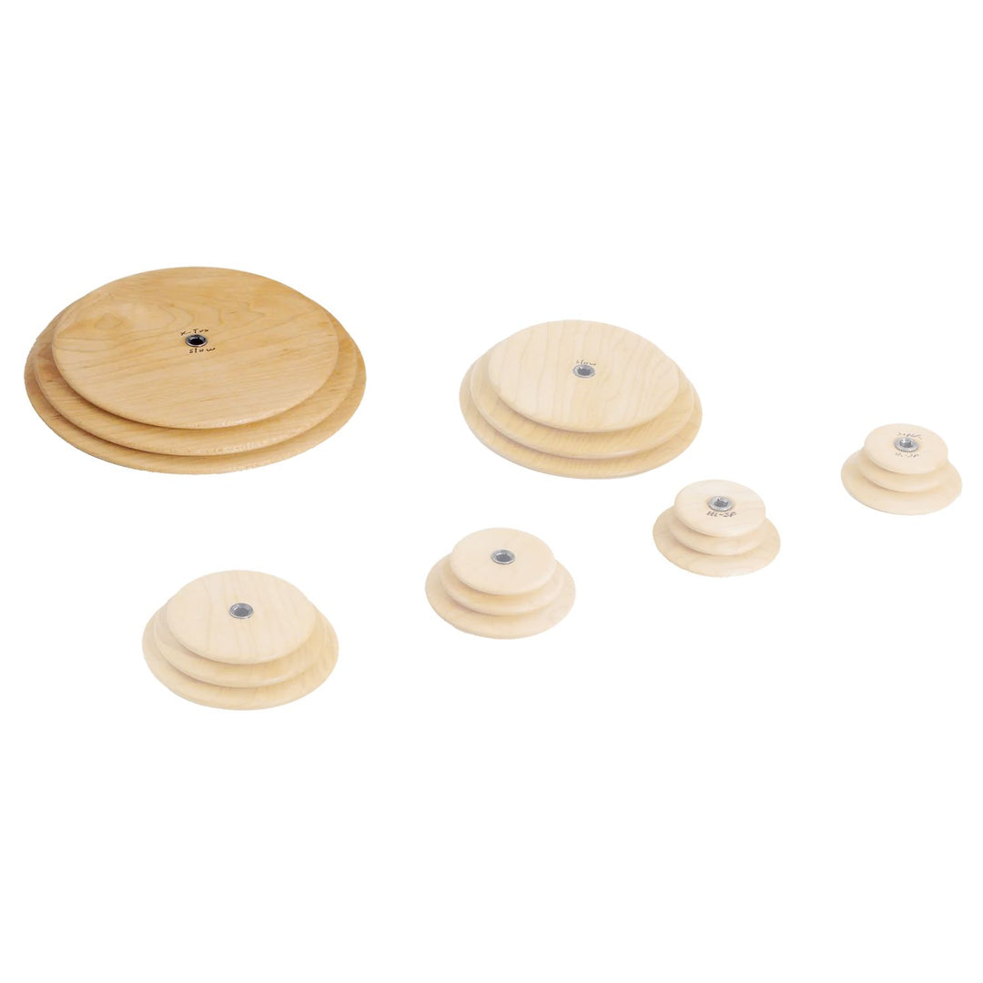 Set of wooden Schacht whorls of different sizes on a white background