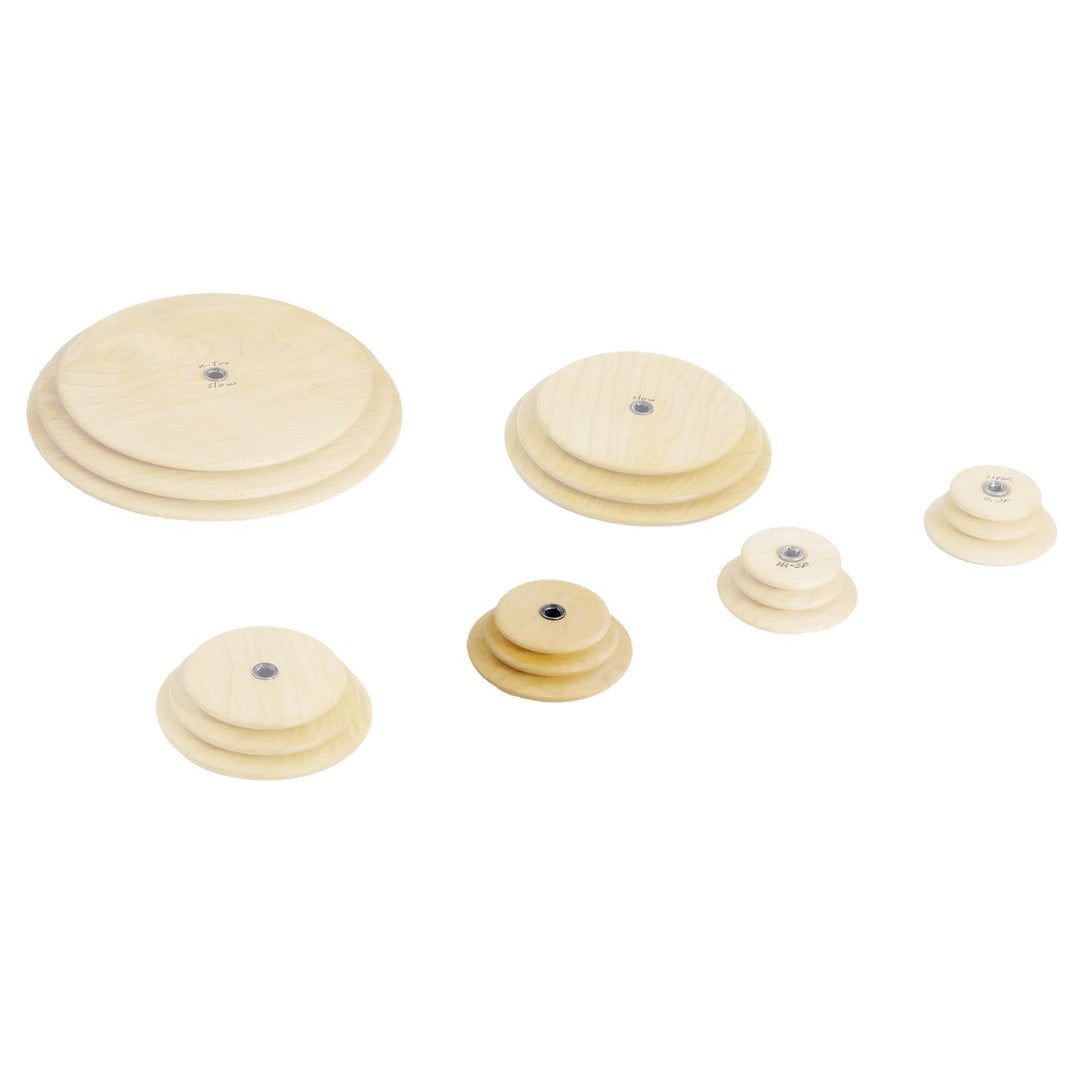 Set of wooden Schacht whorls with the fast speed whorl highlighted on a white background