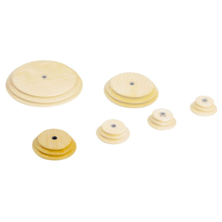 Set of wooden Schacht whorls with the medium speed whorl highlighted on a white background