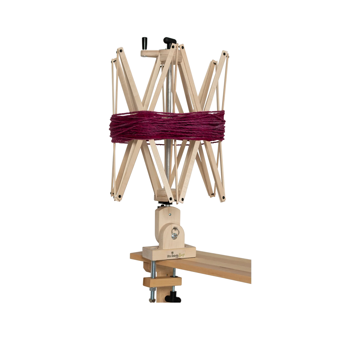 Schacht Ultra Umbrella Swift set up on a wooden table, showcasing its robust design and smooth-turning ball bearings for perfect yarn winding.