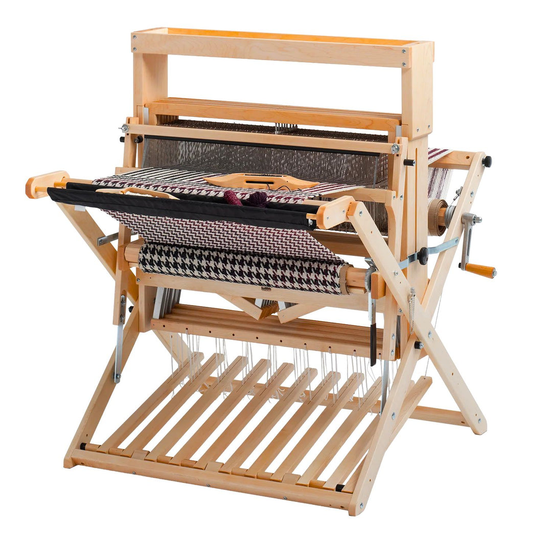Wooden floor weaving loom with fabric on a white background