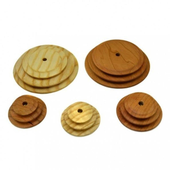 A collection of wooden whorls in varying sizes and wood types for use with Schacht spinning wheels.